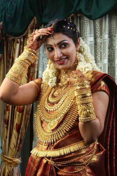 Indian bride wearing traditional 22k gold jewelry during a wedding ceremony